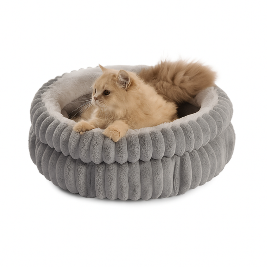 Cat lying on a gray pet bed with ribbed texture on a white background